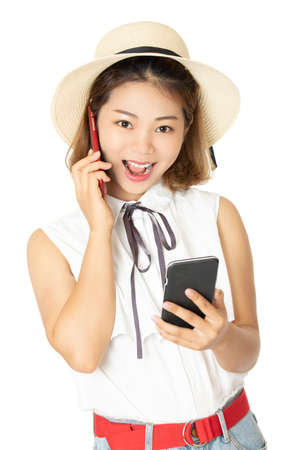 Beautiful Chinese Americn woman talking on two smart phones at the same time isolated on a white backgroundの写真素材