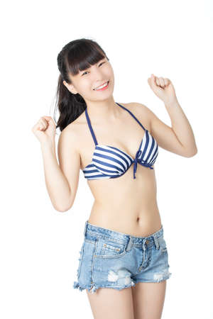 Beautiful Chinese woman wearing a sexy bikini isolated on a white backgroundの写真素材