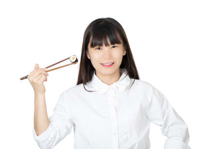 Beautiful Chinese American woman holding sushi with chopsticks isolated on white backgroundの写真素材
