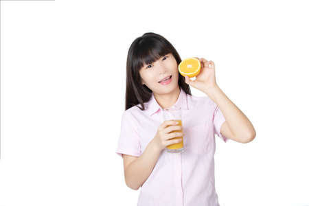 Beautiful Chinese woman drinking orange juice isolated on white backgroundの写真素材