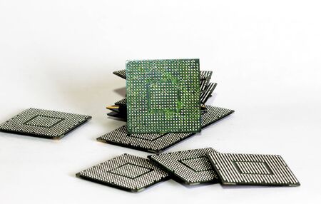 electronic chips isolated on white. The chips are of different colors shapes and sizesの写真素材