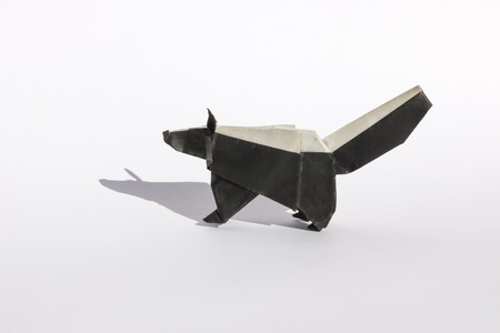 origami skunk isolated on white. the skunk is in black and white colors and appears to be standingの写真素材