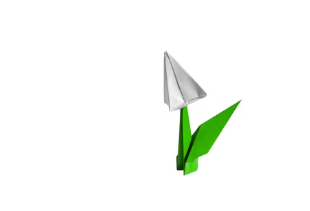 Origami tulip flower.
The tulip is isolated on white background and casts shadow on the surface. It has closed or open petals and a green stalk.の写真素材