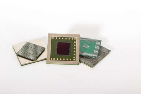electronic chips isolated on white background. The chips are of different colors shapes and sizes.の写真素材