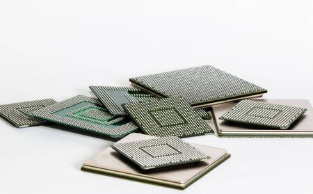electronic chips isolated on white background. The chips are of different colors shapes and sizes.の写真素材