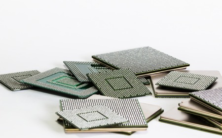 electronic chips isolated on white background. The chips are of different colors shapes and sizes.の写真素材