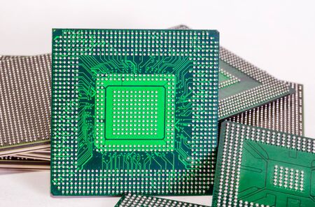 electronic chips isolated on white background. The chips are of different colors shapes and sizes.の写真素材