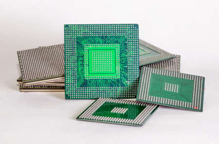 electronic chips isolated on white background. The chips are of different colors shapes and sizes.の写真素材