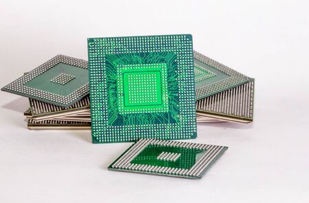 electronic chips isolated on white background. The chips are of different colors shapes and sizes.の写真素材