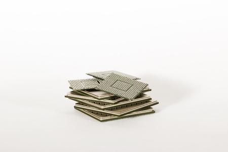 electronic chips isolated on white background. The chips are of different colors shapes and sizes.の写真素材