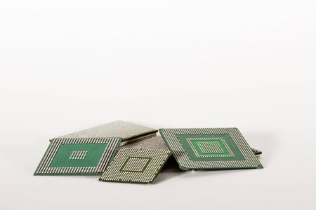 electronic chips isolated on white background. The chips are of different colors shapes and sizes.の写真素材