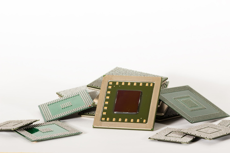 electronic chips isolated on white background. The chips are of different colors shapes and sizes.の写真素材
