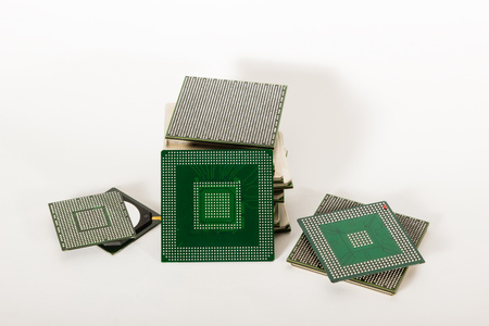 electronic chips isolated on white background. The chips are of different colors shapes and sizes.の写真素材