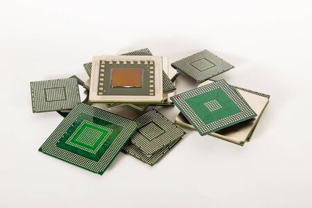 electronic chips isolated on white background. The chips are of different colors shapes and sizes.の写真素材