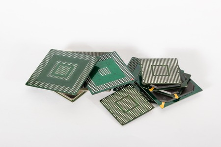 electronic chips isolated on white background. The chips are of different colors shapes and sizes.の写真素材
