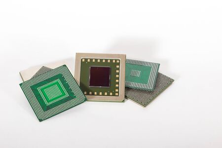 electronic chips isolated on white background. The chips are of different colors shapes and sizes.の写真素材