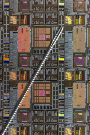 Silicon wafer with printed electronic circuit compared to a needleの写真素材