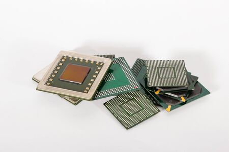 electronic chips isolated on white background. The chips are of different colors shapes and sizes.の写真素材