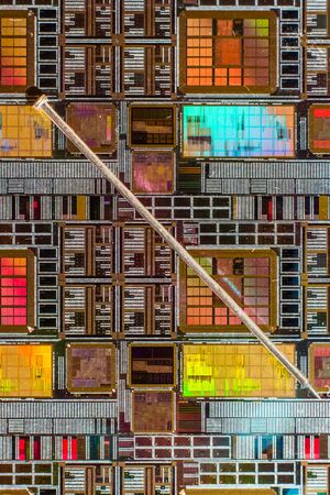 Silicon wafer with printed electronic circuit compared to a needleの写真素材