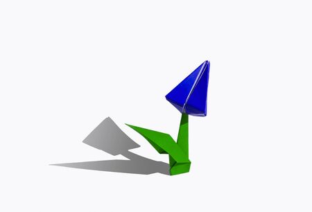 Origami tulip flower.
The tulip is isolated on white background and casts shadow on the surface. It has closed or open petals and a green stalk.の写真素材