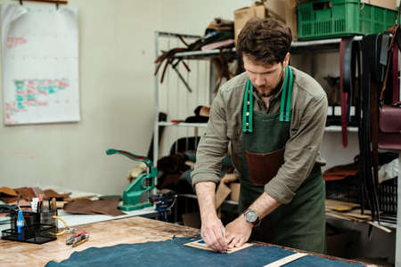 A master works with genuine leather making exclusive things