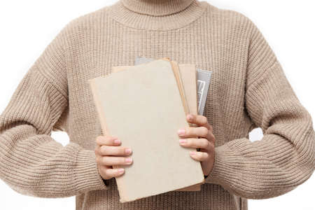 A stack of books in woman's handsの写真素材