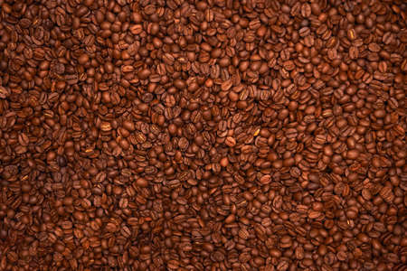 Background of roasted coffee beens. Texture of brown coffee beens.