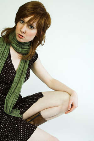 Red haired beauty in fashionable pose