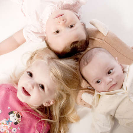 little children portraits taken in the studio on a white backgroundの写真素材