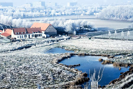 Winter landscape farm house with lake sceneryの写真素材