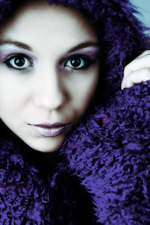 Beautiful young goodlooking woman with a pluche sweaterの写真素材