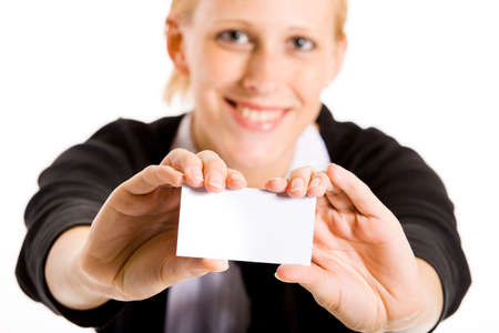 Business woman presenting her white card. Focus in on the hand with the empty white card.の写真素材