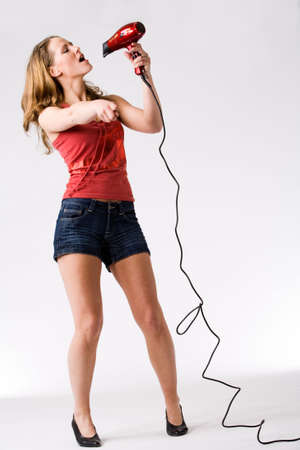 Young woman is singing with a chenookの写真素材