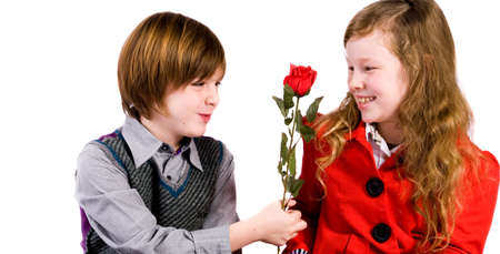 Young children couple with a red roseの写真素材