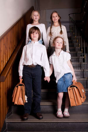Group of little students with different ageson the stairsの写真素材
