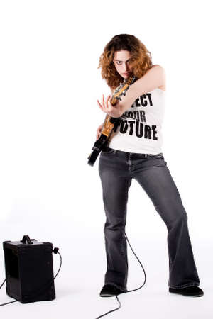 Young female bass guitar player specially isolated on whiteの写真素材