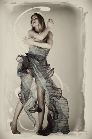 Portrait of a thin woman in a designer dress high fashion style