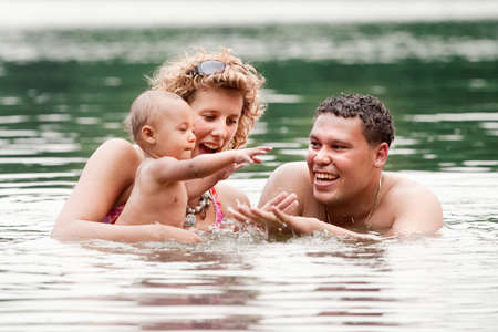 The family and a happy babys first day out in the park