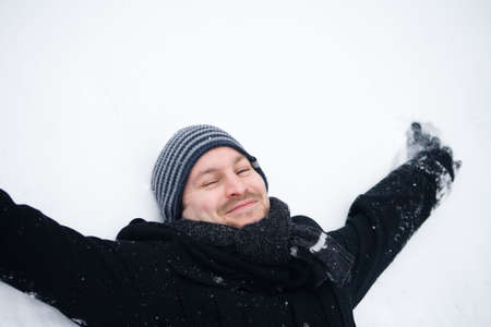 Happy couple in the snow having some fun togetherの写真素材