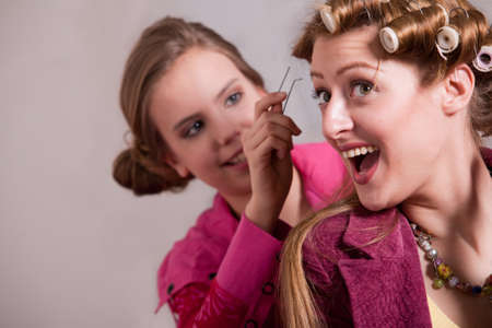 Woman and her children in a bedroom doing girl thingsの写真素材