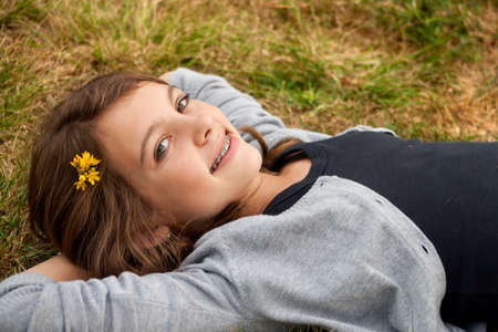 Young summer girl portrait in the grass