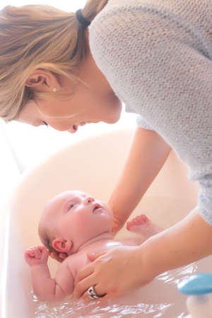 Happy young parents and their little babyの写真素材