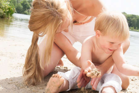 Happy mother and son having a nice day at the beachの写真素材
