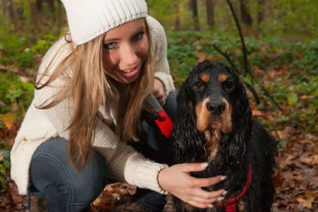Girl and her dog are having a wet time in the rain