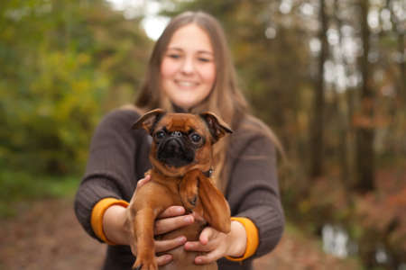 Young teenage girl is having a nice time in the cold novemberの写真素材