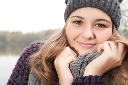 Young teenage girl is having a nice time in the cold novemberの写真素材