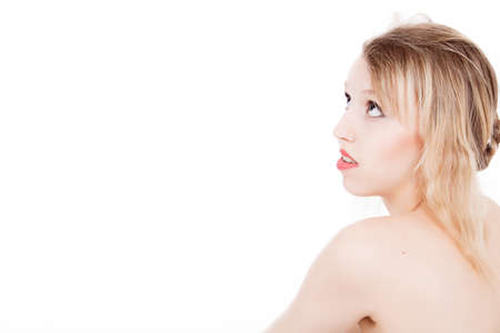 Portrait from young blond woman on a white background with much skin visibleの写真素材