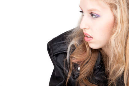 Young tough blond teenage girl with leather jacket on a white backgroundの写真素材