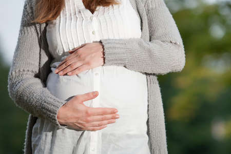 Young new mother is having fun outsideの写真素材