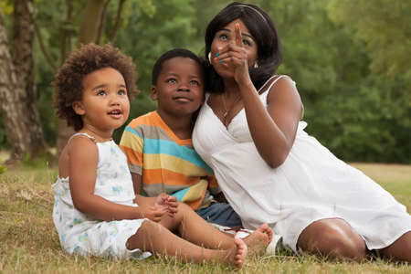 African mother and her kids are having fun in the natureの写真素材